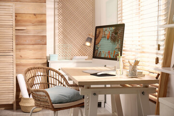 Comfortable workplace with modern computer near window. Interior design