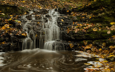 Long exposure Virsaisu waterfall in autumn day, Latvia.