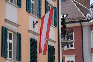 Austrian flag blowing in the wind at the old town of Bregenz on a sunny summer Sunday. Photo taken August 15th, 2021, Bregenz, Austria.