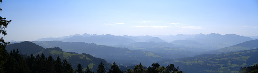 Beautiful wide angle scenic mountain panorama seen from local mountain Pfänder on a sunny summer day. Photo taken August 15th, 2021, Bregenz, Austria.
