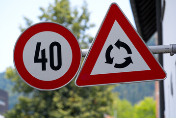 Traffic signs speed limit 40 kilometers per hour and attention roundabout ahead. Photo taken August 15th, 2021, Bregenz, Austria. 
