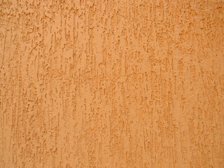 earth-coloured wall cladding, known as grafiato