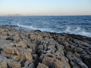 waves crashing on rocks during sunset  in mediterranean August 29  2021 