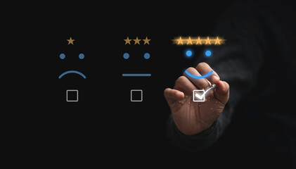 Businessman touching button to select five stars with smiley face for the best excellent evaluation...