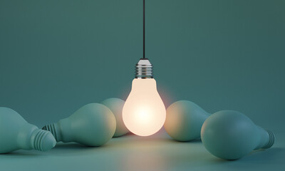 One of Lightbulb glowing among shutdown light bulb  in dark area with copy space for creative...