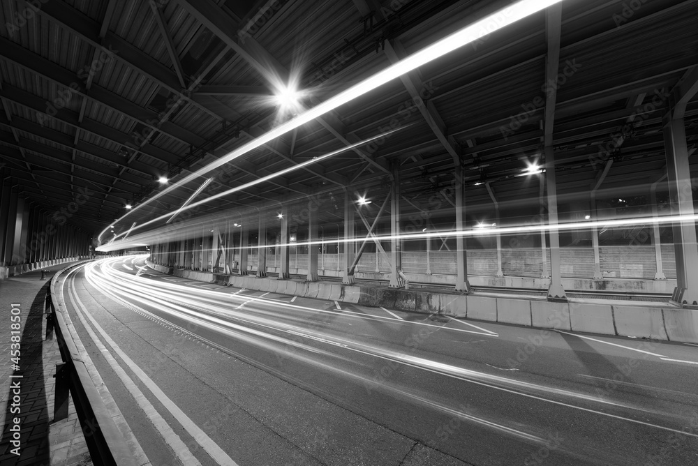 Poster light trails and head lights of traffic in tunnel. transportation background