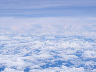 Aerial view of clouds and sky as seen through the window of an aircraft