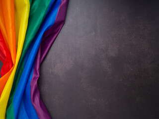 The rainbow flag (LGBT) is on a vintage background. Top view. Flat lay. Space for text. Love concept