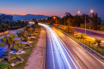 Car lights on the Mediterranean coast highway in Alanya at dawn, Turkey