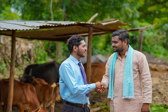 Young Indian Agronomist Or Officer Visiting To Farmer At His Farm