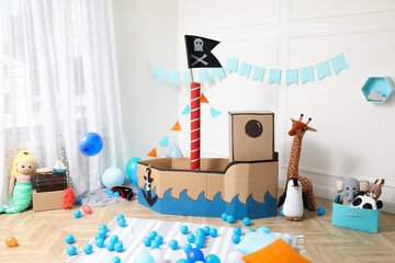 Child's room interior with pirate cardboard ship and toys