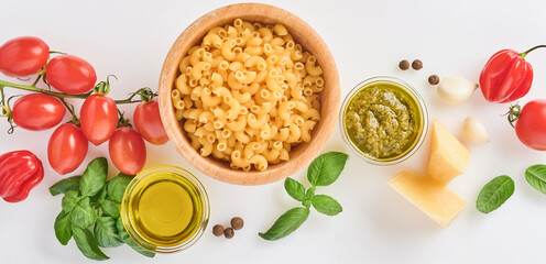 Spaghetti, fresh tomato, herbs and spices. Composition of healthy food ingredients isolated on white background, top view. Mock up.