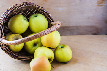 apples in an inverted wooden basket on the table