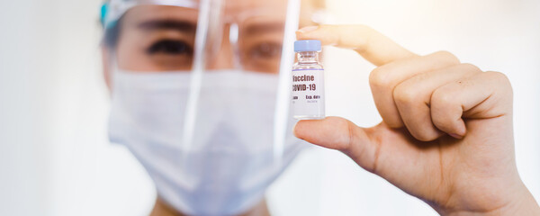 Close up woman doctor holding coronavirus vaccine