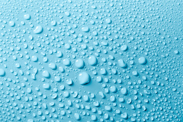 Water drops on smooth surface, blue background