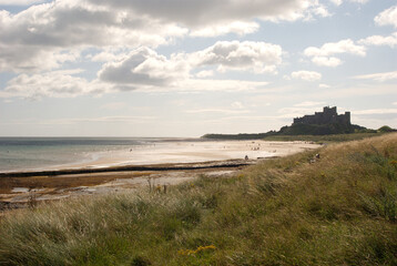 Obraz premium Bamburgh castle and beach in summer sunshine