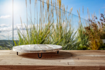 Wooden platform on the table for standing product against the background of the autumn sea...