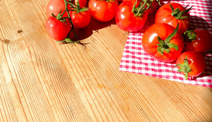 Red tomatoes on wooden background. Fresh vegetables top view with copy space for text. Flat lay. The concept of the harvest, vegetable garden. Natural products, agriculture. Lay out