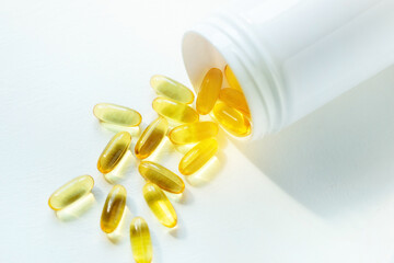omega 3 fatty acid capsules fish oil on white background