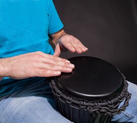 Man Playing the African Djembe Drum