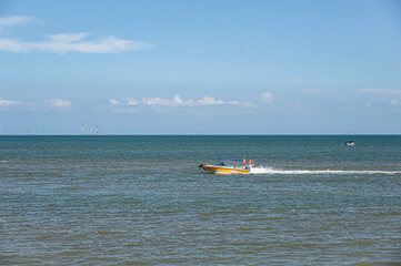 On a sunny day in summer, the speedboat drove fast in the blue sea
