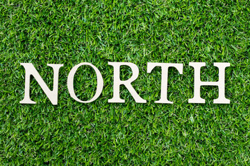 Wood alphabet letter in word north on green grass background