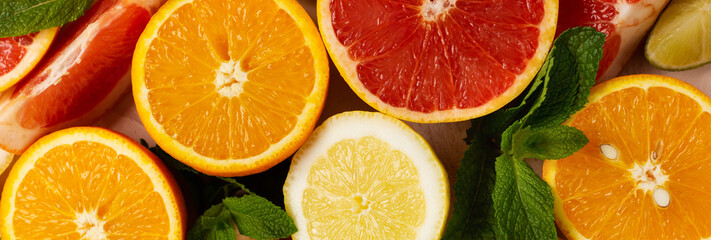 Fototapeta na wymiar Orange, lemon, grapefruit, mandarin and lime on trendy pink stone or concrete table background. Citrus fruits. Top view, flat lay