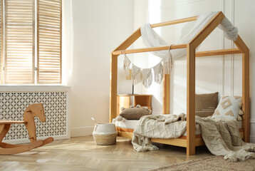 Stylish child room interior with house bed