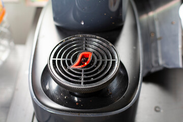 A dirty coffee machine working using capsules in a kitchen