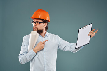 man in orange hard hat engineer blueprints construction work