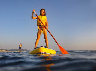 sup surfing in the sea