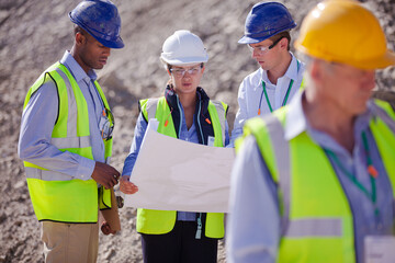 Worker holding clipboard on site