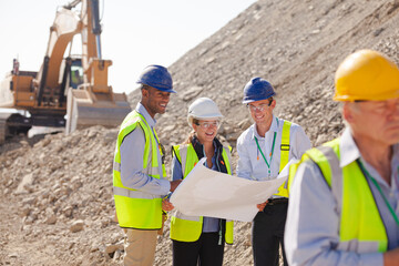 Worker holding clipboard on site