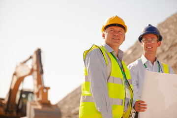 Business people and workers standing in quarry