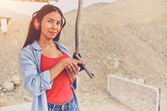 Woman releasing stress, Instructor helping woman with gun