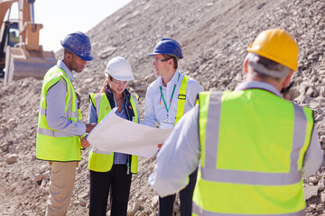 Worker holding clipboard on site