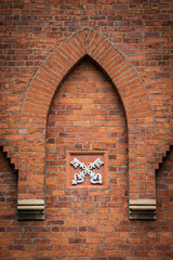 Two crossed keys symbol on an old brick wall. Architecture background.