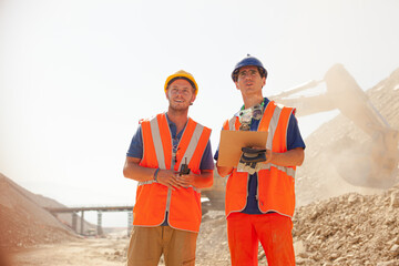 Business people reading blueprints in quarry