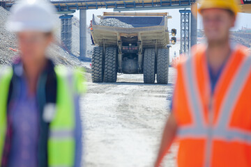 Workers reading blueprints in quarry