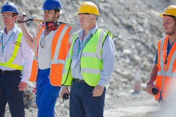 Workers reading blueprints in quarry