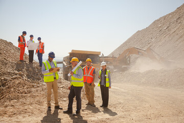 Workers and machinery in quarry