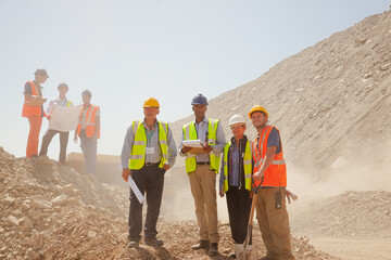 Workers and business people smiling at quarry
