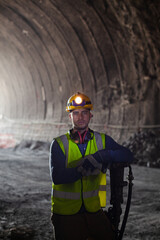 Businessman and worker standing in tunnel