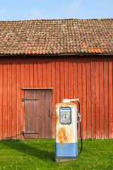 Old gas pump at a red barn