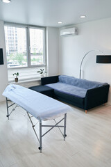 Naklejka na ściany i meble Image of medical rehabilitation office with massage table