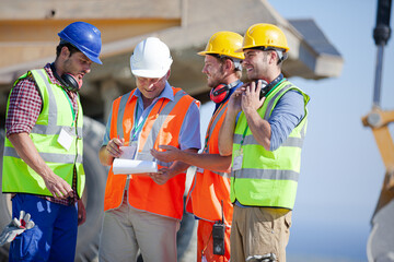 Worker standing on machinery on site