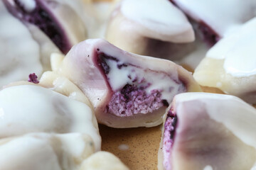 Sweet dumplings with purple fruits and cottage cheese.