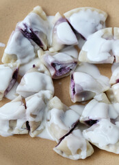 Sweet dumplings with purple fruits and cottage cheese.