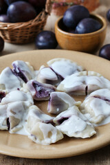 Sweet dumplings with purple fruits and cottage cheese.