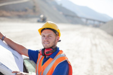 Workers reading blueprints on site